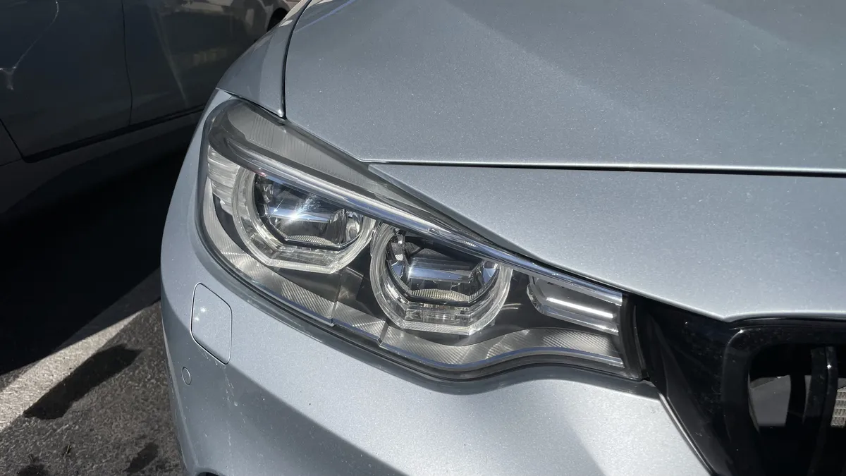 After professional headlight restoration on 2013 BMW 3-Series (Driver Side) in Tucson, AZ with UV protection applied.