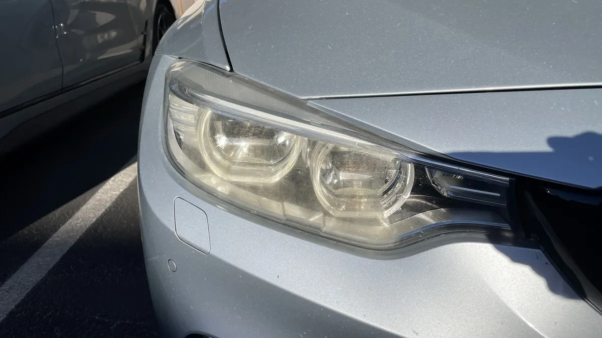 Before professional headlight restoration on 2013 BMW 3-Series (Driver Side) in Tucson, AZ showing severe lens oxidation.