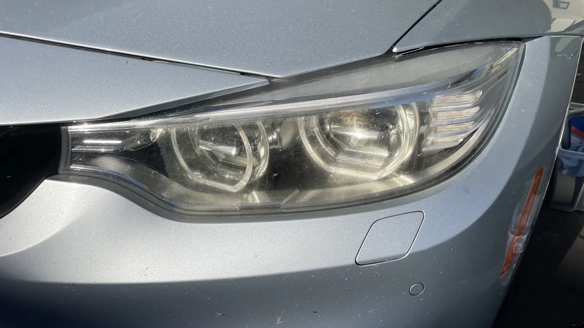 Before professional headlight restoration on 2013 BMW 3-Series (Passenger Side) in Tucson, AZ showing severe lens oxidation.