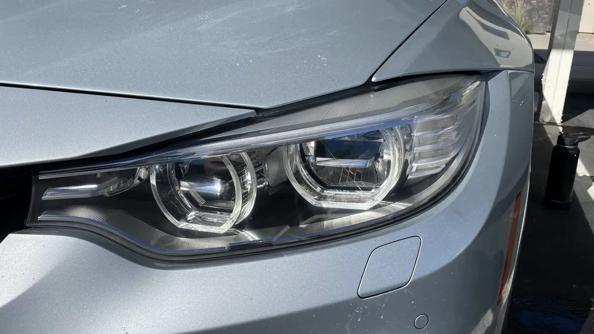 After professional headlight restoration on 2013 BMW 3-Series (Passenger Side View) in Tucson, AZ with UV protection applied.