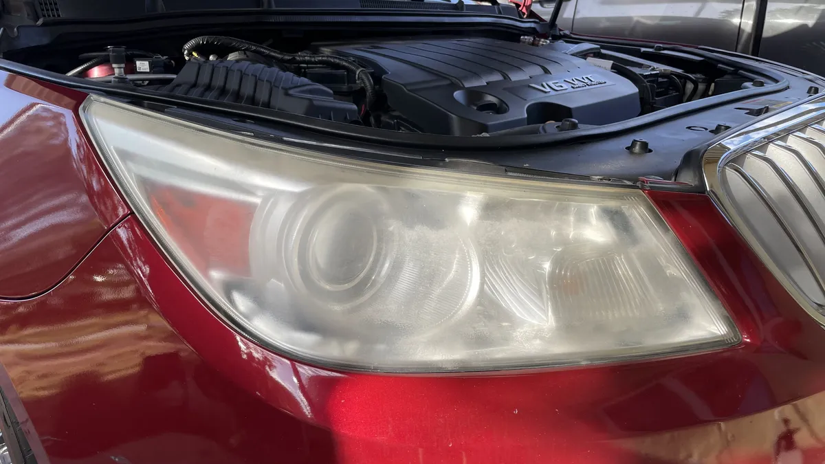 Before professional headlight restoration on 2012 Buick LaCrosse in Tucson, AZ showing severe lens oxidation.
