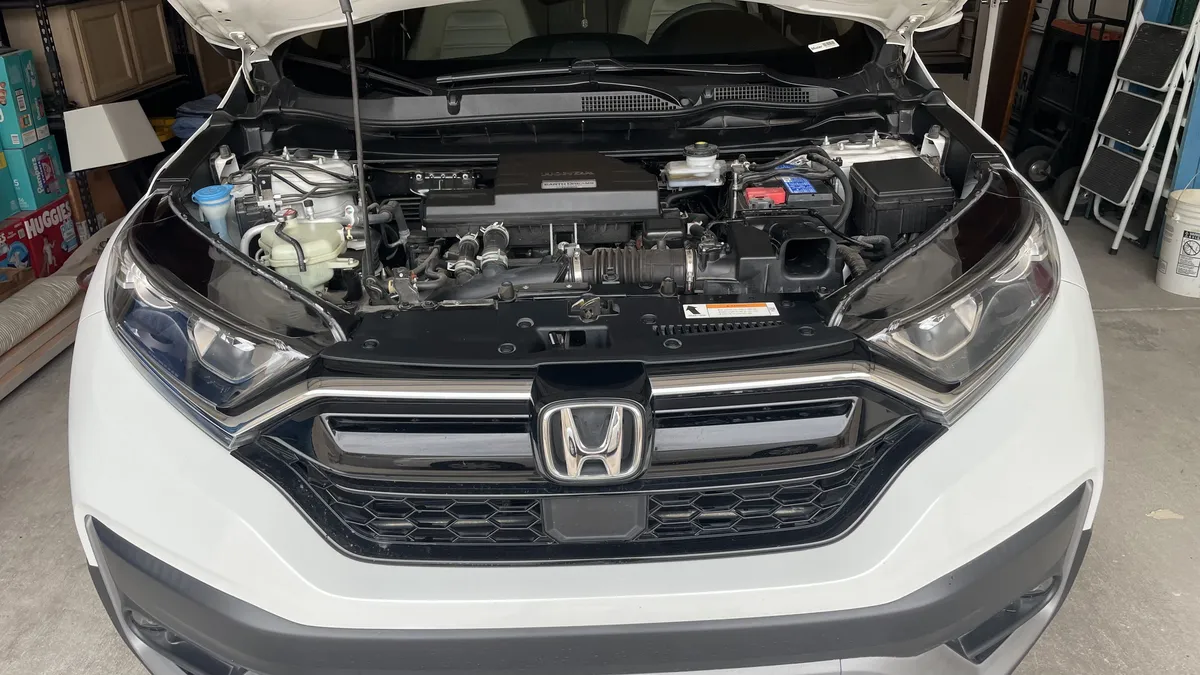 Honda CR-V engine bay detail during headlight restoration inspection.