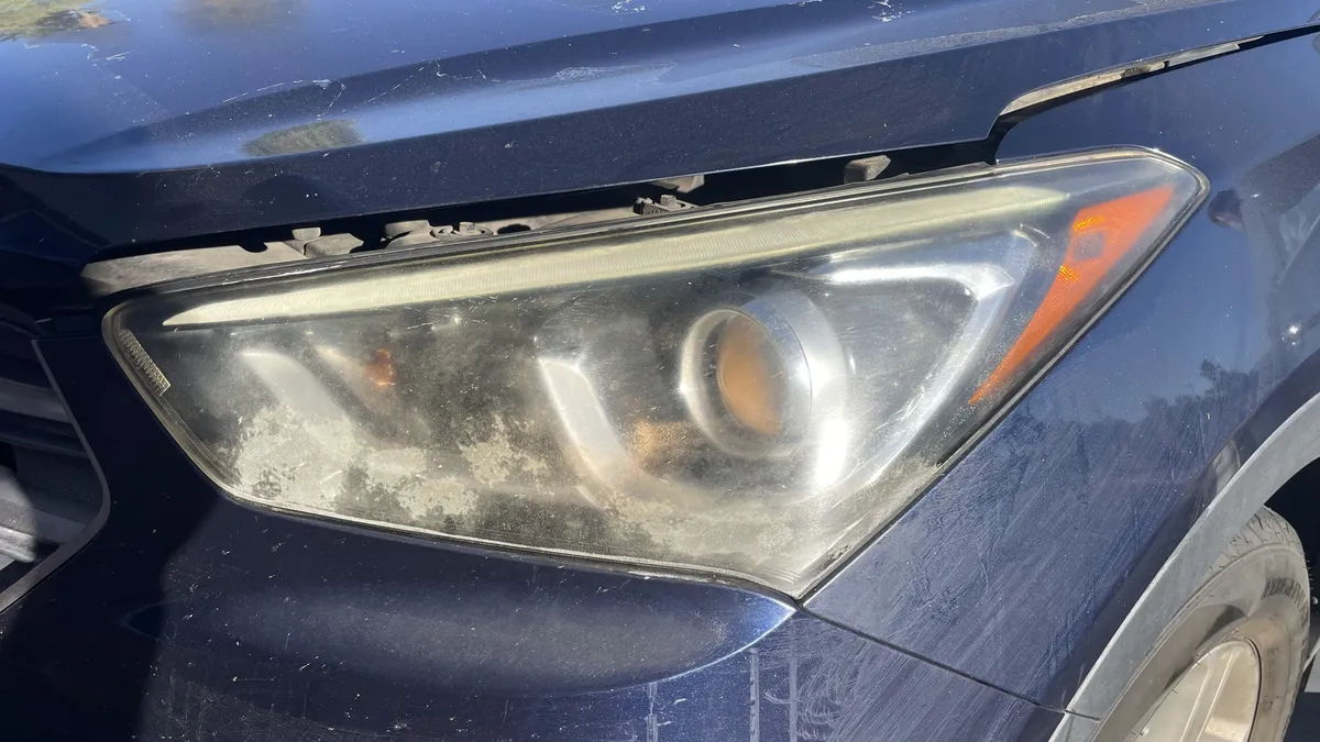 Before professional headlight restoration on 2015 Hyundai Santa Fe in Tucson, AZ showing severe lens oxidation.
