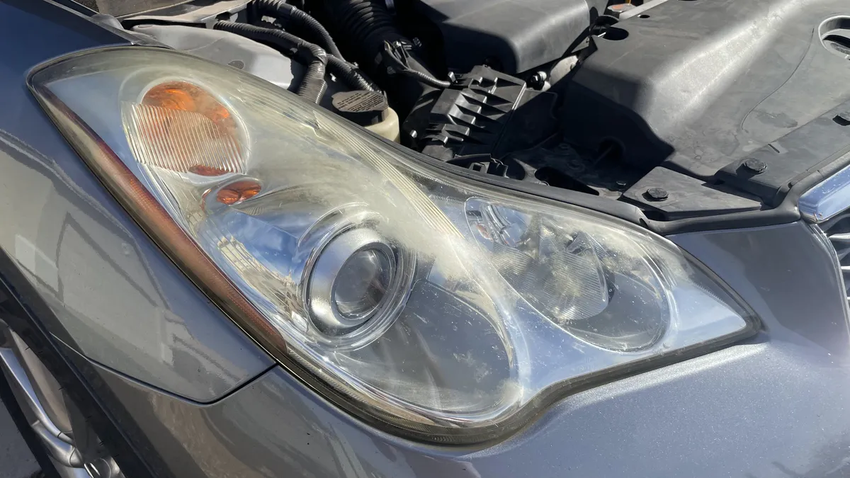 Before professional headlight restoration on 2008 Infiniti EX35 (Driver Side) in Tucson, AZ showing severe lens oxidation.