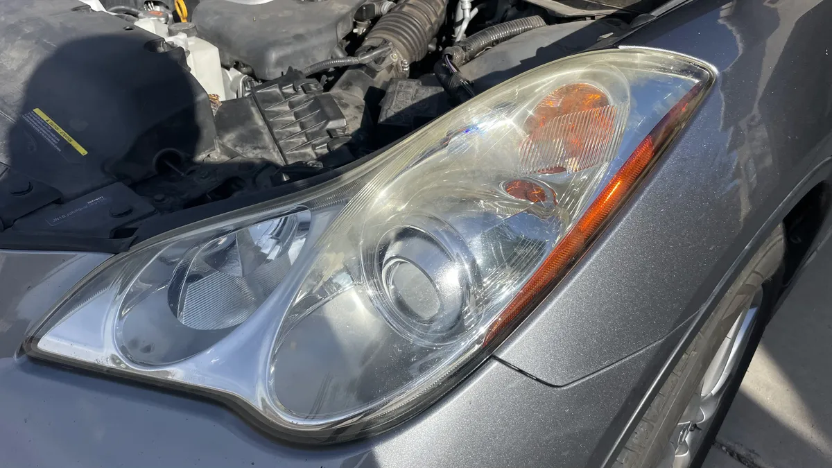 Before professional headlight restoration on 2008 Infiniti EX35 (Passenger Side) in Tucson, AZ showing severe lens oxidation.