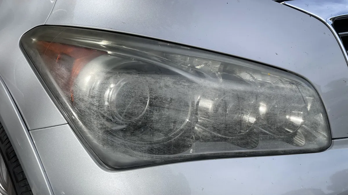 Before professional headlight restoration on 2008 Infiniti G35 Sedan in Tucson, AZ showing severe lens oxidation.
