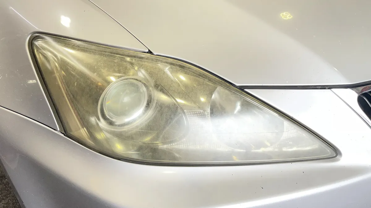 Before professional headlight restoration on 2008 Lexus IS 250 in Tucson, AZ showing severe lens oxidation.