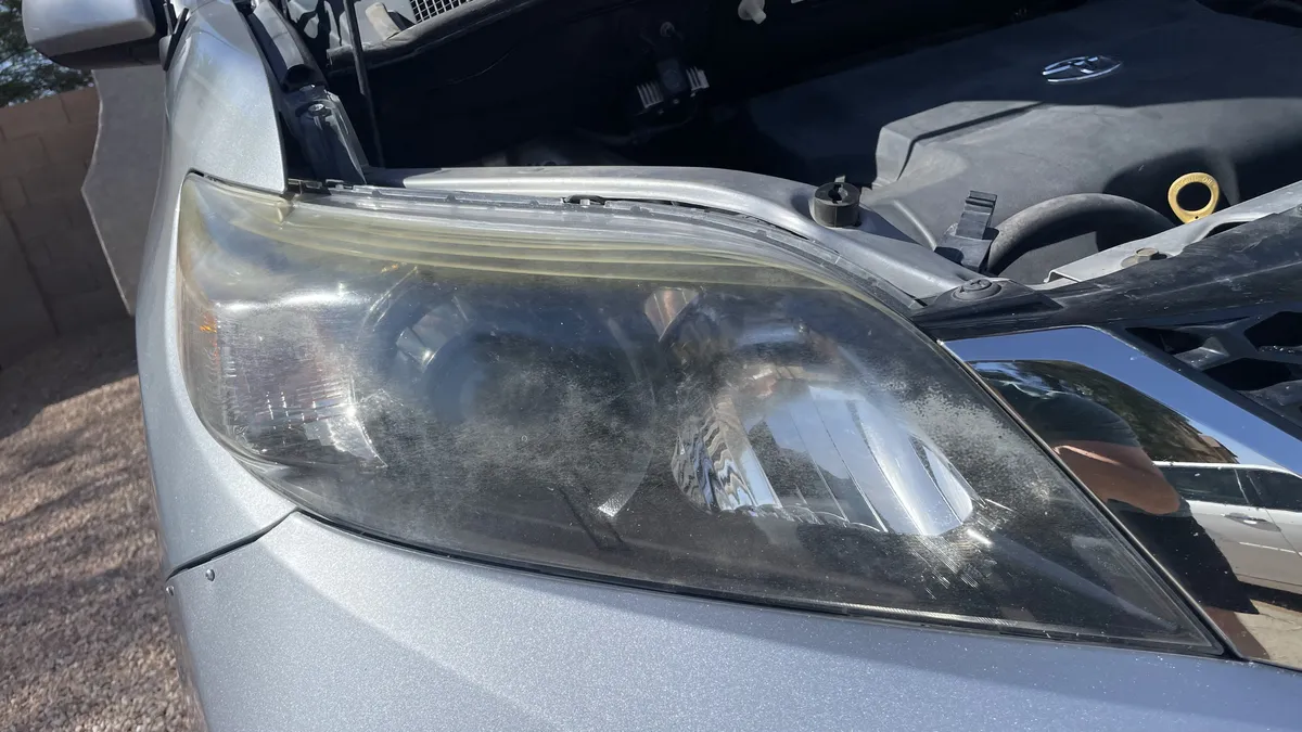 Before professional headlight restoration on 2010 Lexus RX 350 in Tucson, AZ showing severe lens oxidation.