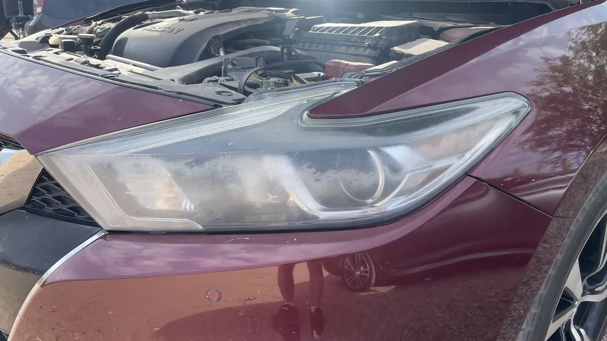 Before professional headlight restoration on 2016 Nissan Maxima in Tucson, AZ showing severe lens oxidation.