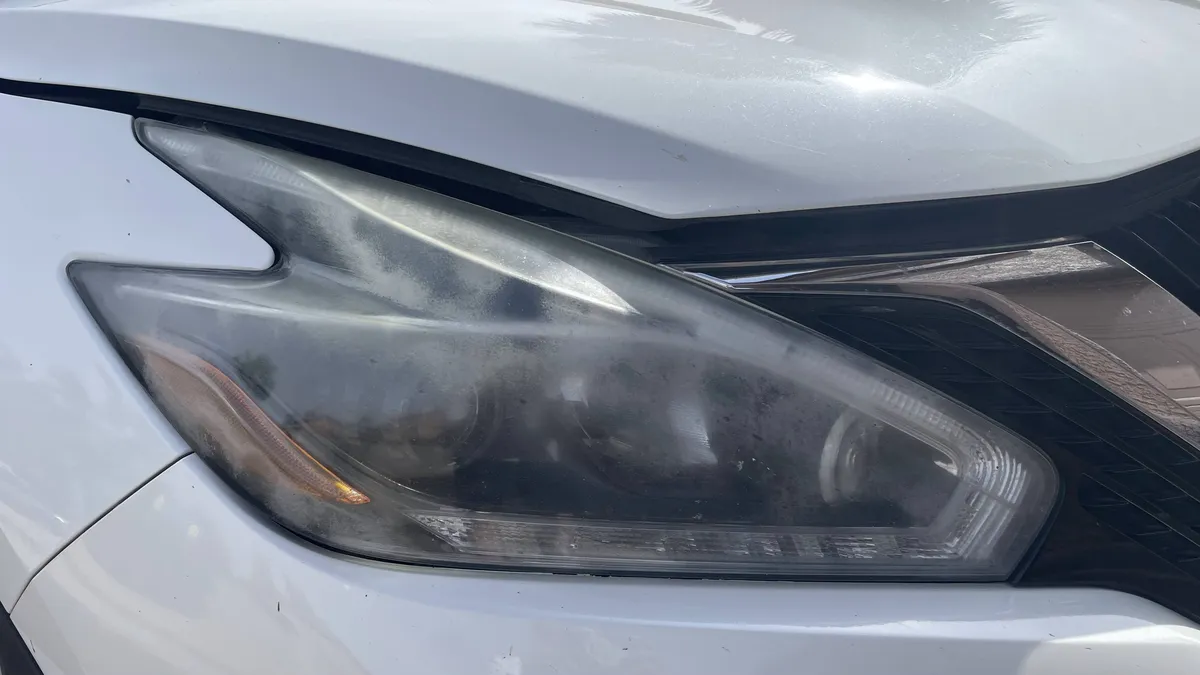 Before professional headlight restoration on 2017 Nissan Murano in Tucson, AZ showing severe lens oxidation.