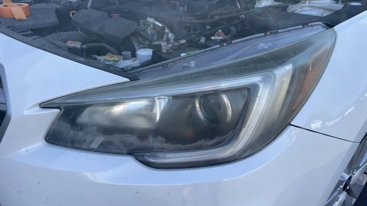 Before professional headlight restoration on 2016 Subaru Outback in Tucson, AZ showing severe lens oxidation.
