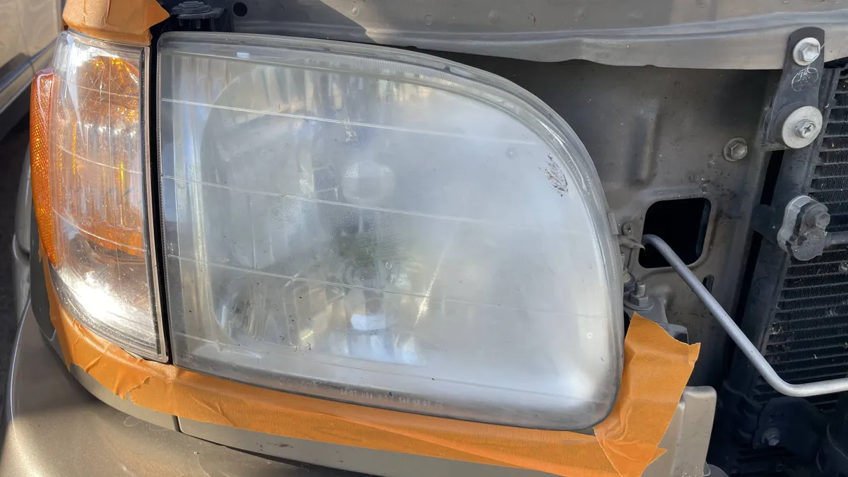 Before professional headlight restoration on 2004 Toyota Sequoia in Tucson, AZ showing severe lens oxidation.