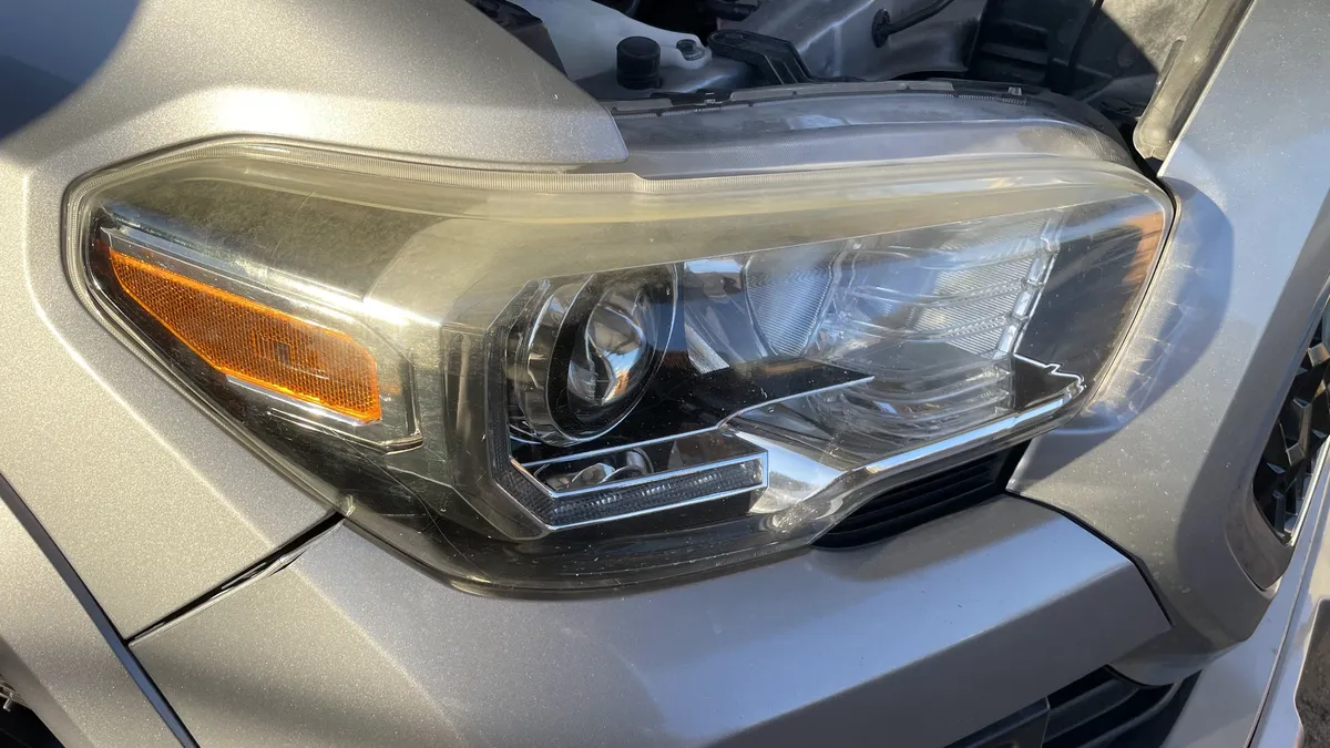 Before professional headlight restoration on 2017 Toyota Tacoma in Tucson, AZ showing severe lens oxidation.