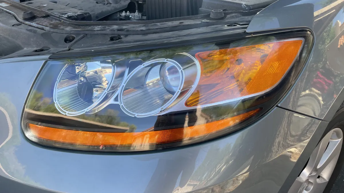 Driver checking headlights before a Tucson road trip.