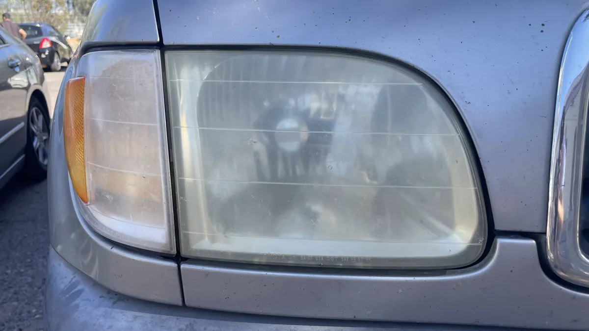 Oxidized yellow headlight before professional restoration in Tucson
